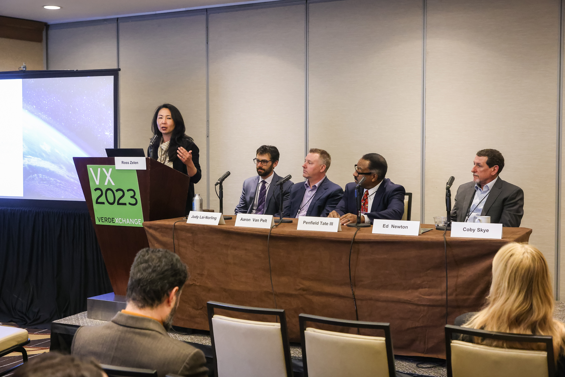 Carbon Mapper's Judy Lai Norling speaking in front of panel with CA Legislature's Ross Zelen, QLM's Aaron Van Pelt, Project Canary's Penfield Tate III, and SoCal Gas's Ed Newton